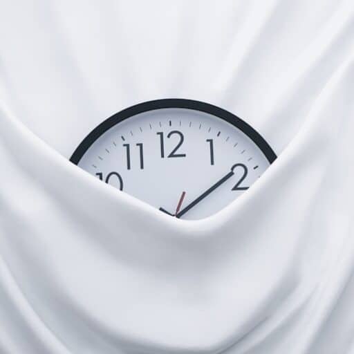 round black clock on linen