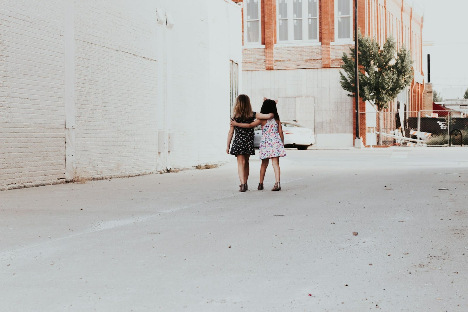 Photo by Andrea Tummons two girls walking on street